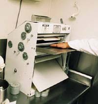 Hand in pizza crust maker